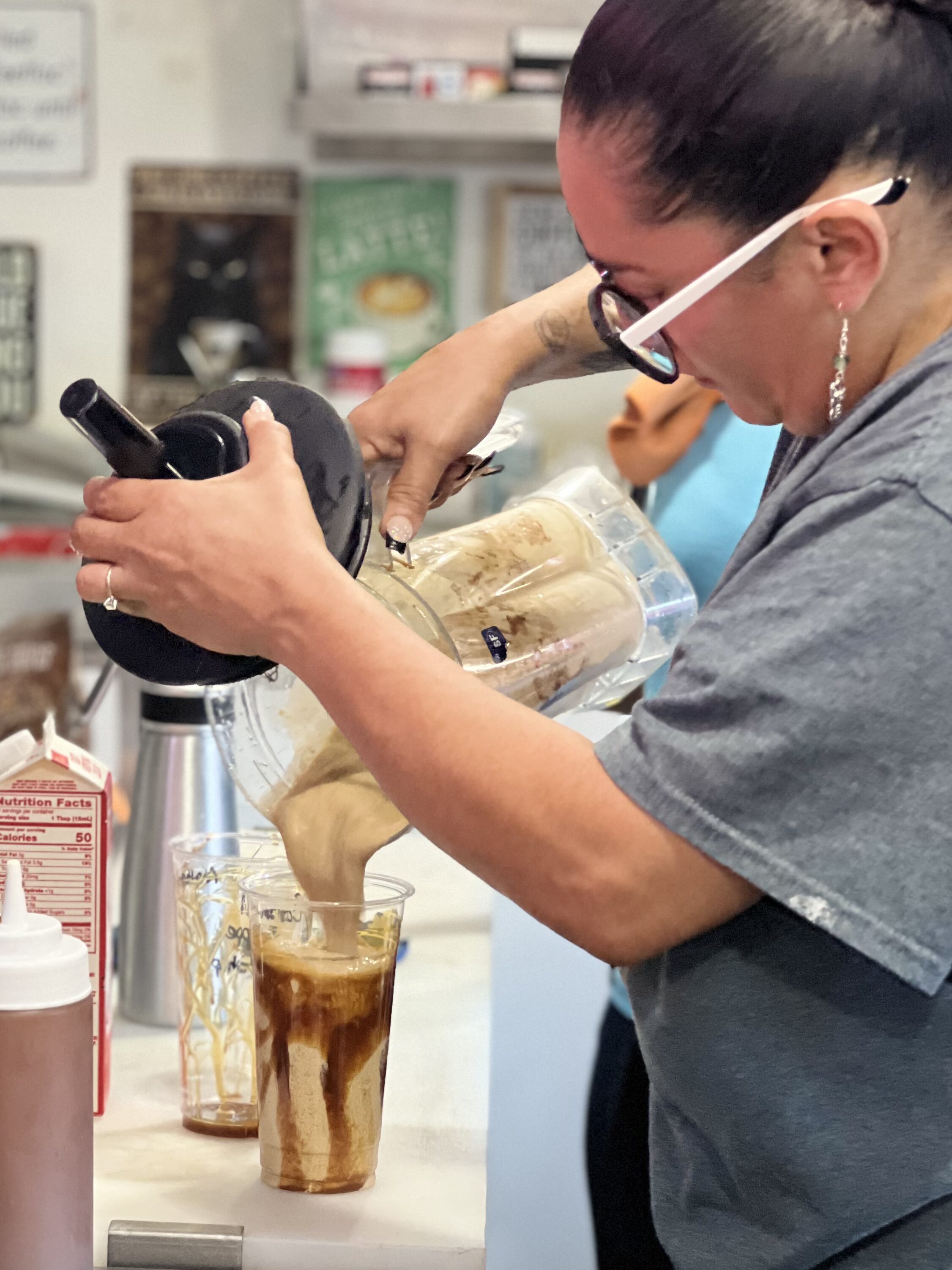 Jazzy inside the Mocha Motion Coffee truck pouring a frappe