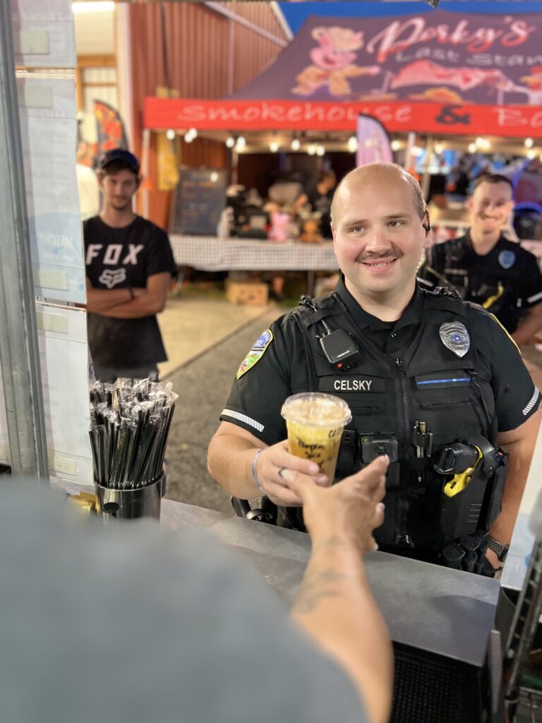 Police officer reaching for their drink at the Mocha Motion Coffee service window.